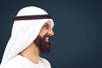 Image showing Arabian saudi businessman on dark blue studio background