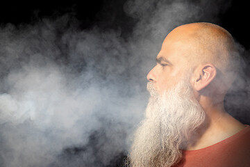 Image showing bearded man gets smoke in his face portrait