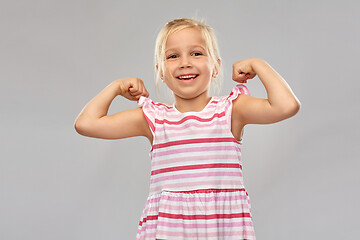 Image showing smiling little girl showing her power