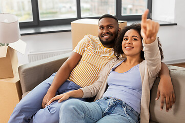 Image showing happy couple with boxes moving to new home