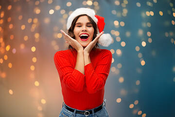 Image showing happy young woman in santa hat on christmas