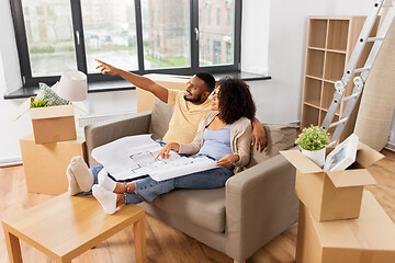 Image showing couple with boxes and blueprint moving to new home