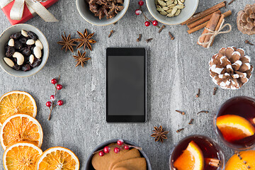 Image showing smartphone, hot mulled wine and christmas spices