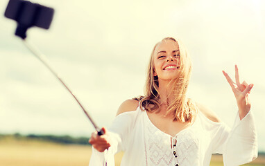 Image showing happy young woman taking selfie by smartphone