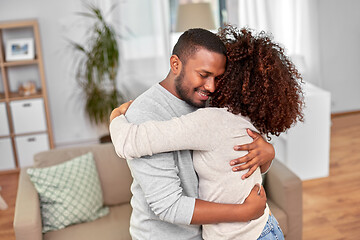 Image showing happy african american couple hugging at home