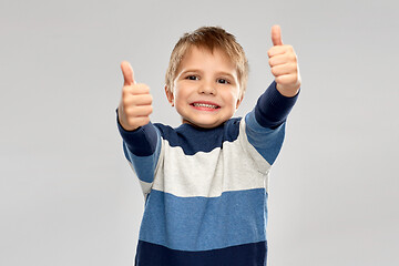 Image showing little boy in striped pullover showing thumbs up