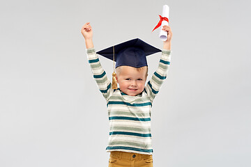 Image showing smiling little boy in mortar board with diploma