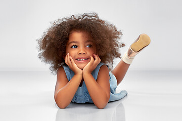 Image showing happy little african american girl lying on floor