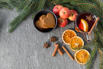 Image showing glass of hot mulled wine, cookies, apples and fir