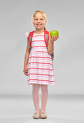 Image showing little school girl with green apple