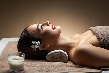 Image showing young woman lying at spa or massage parlor