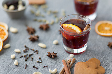 Image showing hot mulled wine, orange slices, raisins and spices