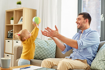 Image showing father and baby daughter playing with ball at home