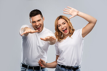 Image showing portrait of happy couple in white t-shirts dancing