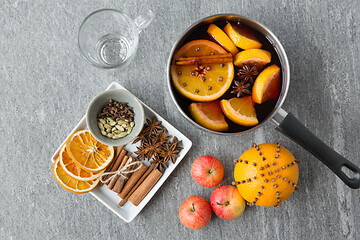 Image showing pot with hot mulled wine, orange slices and spices