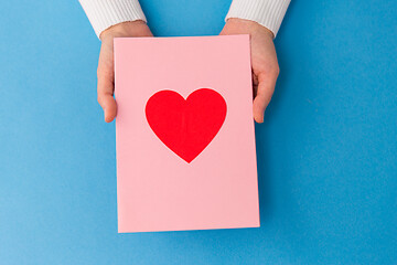 Image showing hands holding greeting card with heart