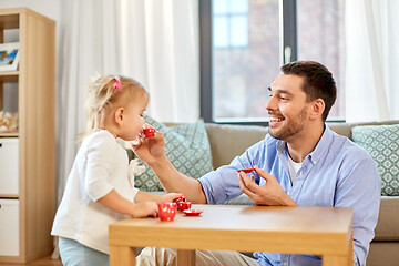 Image showing father and daughter playing tea party at home