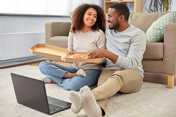 Image showing happy african american couple eating pizza at home