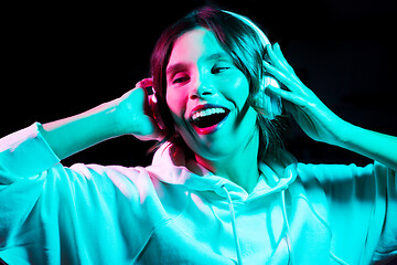 Image showing woman in headphones listening to music and dancing