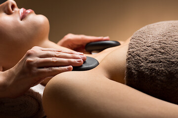 Image showing close up of woman having hot stone massage at spa