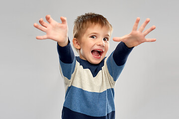 Image showing portrait of scared little boy in striped pullover