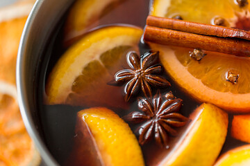 Image showing pot with hot mulled wine, orange slices and spices