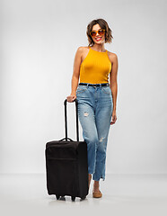 Image showing happy young woman in sunglasses with travel bag