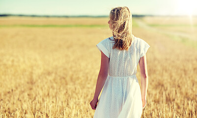 Image showing young woman in white dress on cereal field