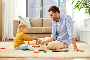 Image showing father playing with little baby daughter at home