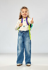 Image showing happy girl with school backpack showing thumbs up