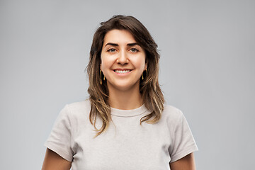 Image showing happy smiling young woman in grey t-shirt