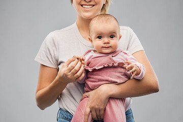 Image showing happy young mother holding little baby daughter
