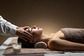 Image showing woman having face and head massage at spa