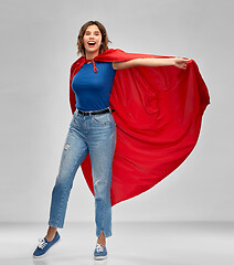 Image showing happy woman in red superhero cape