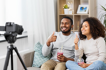 Image showing couple of video bloggers with camera at home