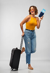 Image showing happy young woman with air ticket and travel bag