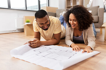 Image showing couple with boxes and blueprint moving to new home