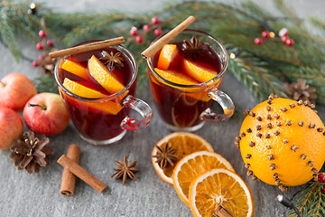 Image showing glass of hot mulled wine, cookies, apples and fir