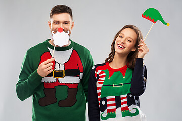 Image showing couple with christmas party props in ugly sweaters