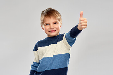 Image showing little boy in striped pullover showing thumbs up