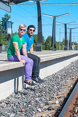 Image showing Shot of two young men sitting on platform