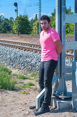 Image showing Handsome young guy in pink t-shirt watching on you