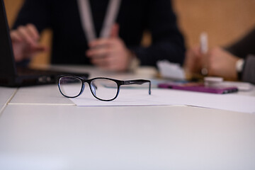 Image showing laptop and glasses at office desk