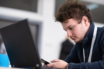 Image showing Young casual businessman using smartphone