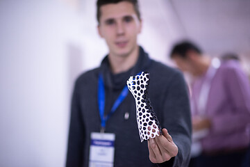 Image showing young engineer showing 3D printed model