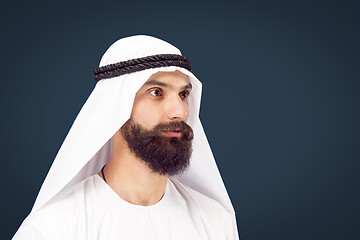 Image showing Arabian saudi businessman on dark blue studio background