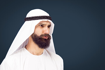 Image showing Arabian saudi businessman on dark blue studio background