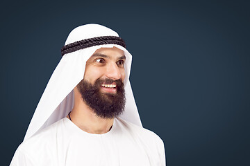 Image showing Arabian saudi businessman on dark blue studio background