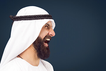 Image showing Arabian saudi businessman on dark blue studio background