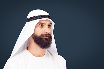 Image showing Arabian saudi businessman on dark blue studio background